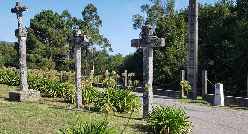 three crosses on the portuguese camino by a mile marker