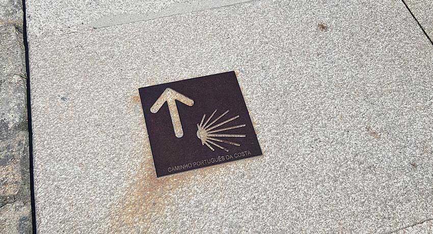 street plaque on the floor marking portuguese Camino