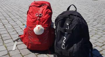 two backpacks laying side by side