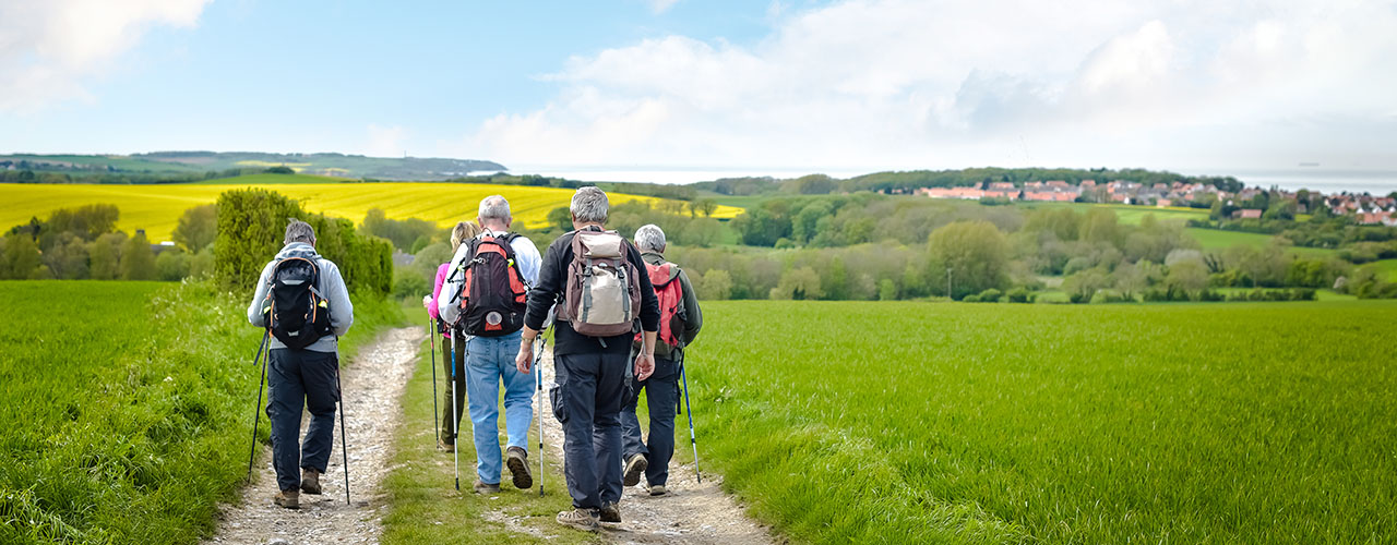 seniors with backpacks on a camino pilgrimage trail