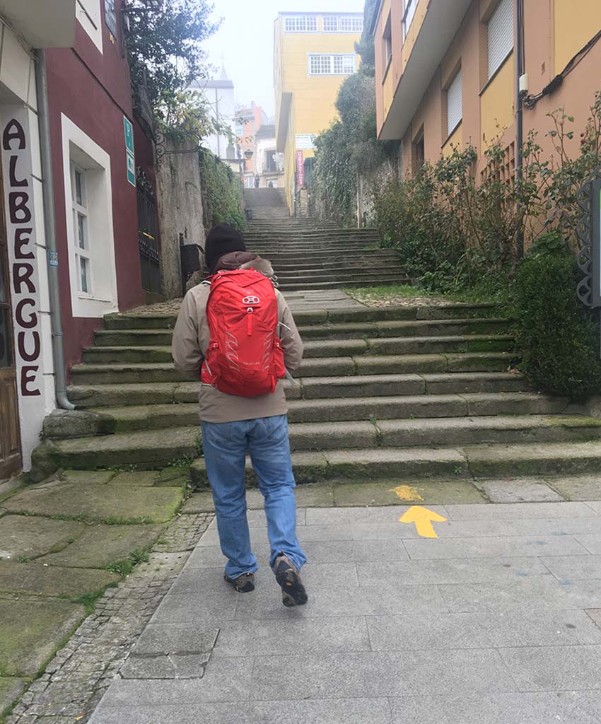 pilgrim walking in the city of Sarria in winter