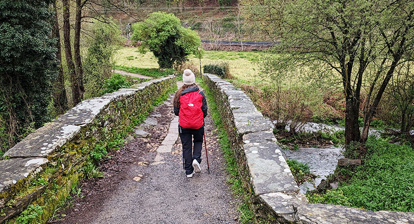 pilgrim walking on bridge