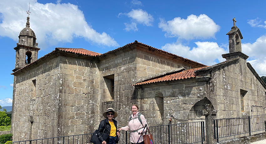 pilgrims by church along the portuguese Camino