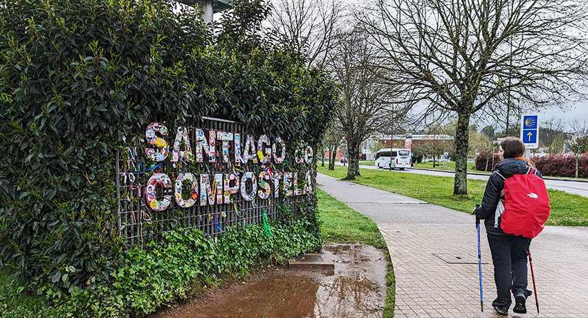 pilgrim walking on el Camino arriving in Santiago