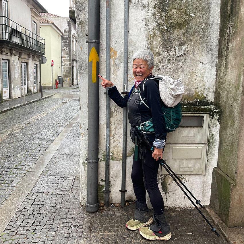 pilgrim pointing to an arrow that leads the way
