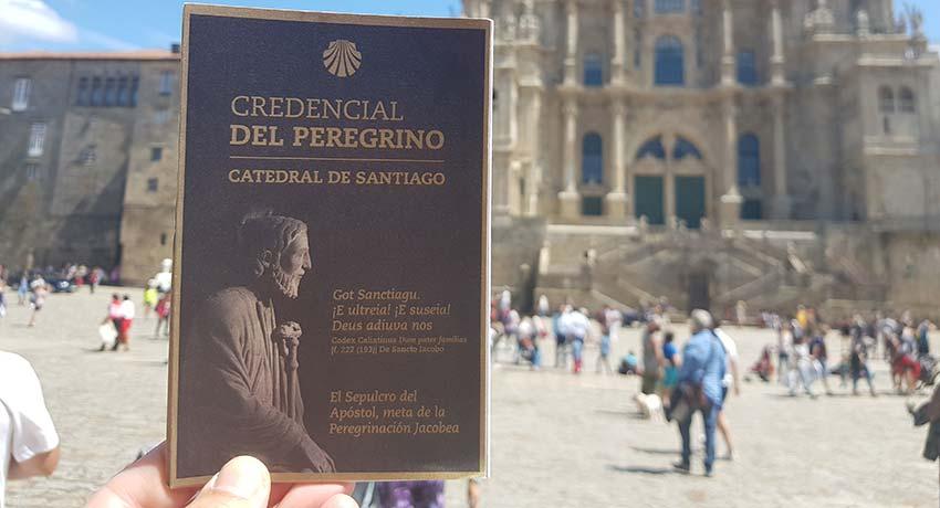 pilgrim credential in front of the Santiago cathedral
