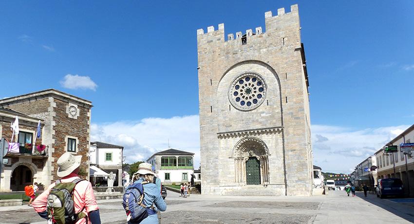 pilgrims admiring the church in Portomarín