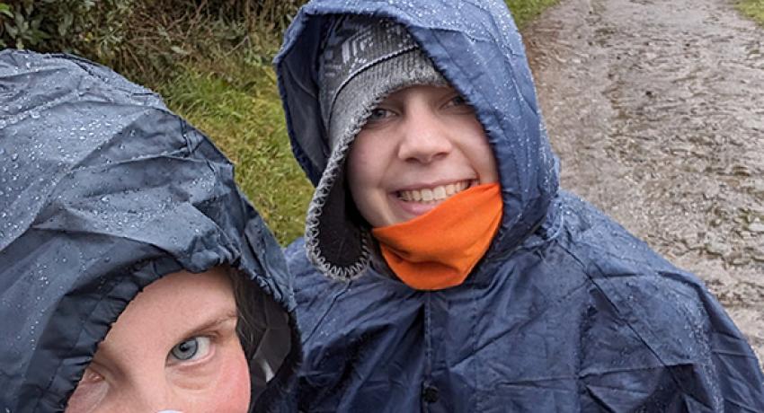 pilgrims smiling wearing weather gear on el Camino de Santiago