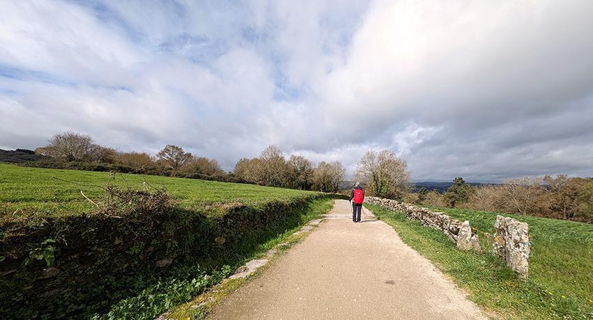 pilgrim in the distance walking along el Camino de Santiago