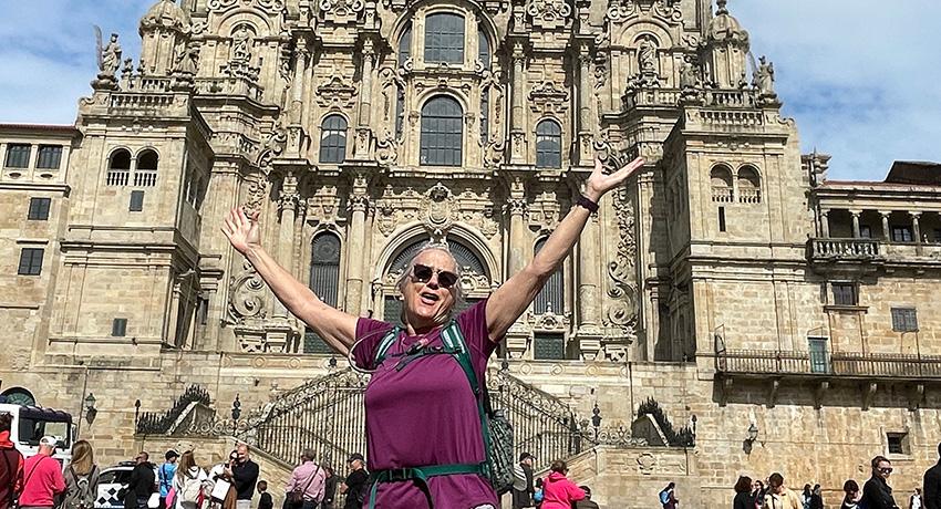 Pilgrim celebrating her arrival in front of the Santiago Cathedral