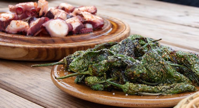 pepper and octopus tapas on wooden table