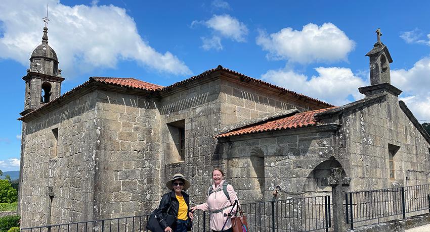 pilgrims by church along the portuguese camino