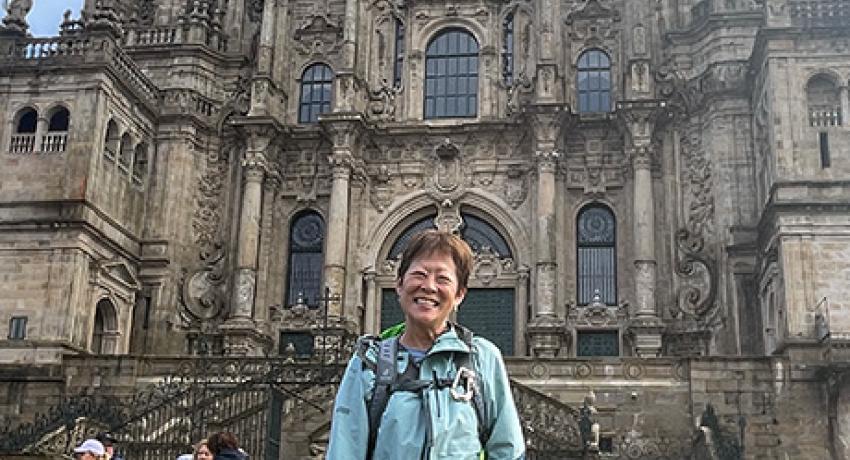 pilgrim posing in front of Santiago's Cathedral