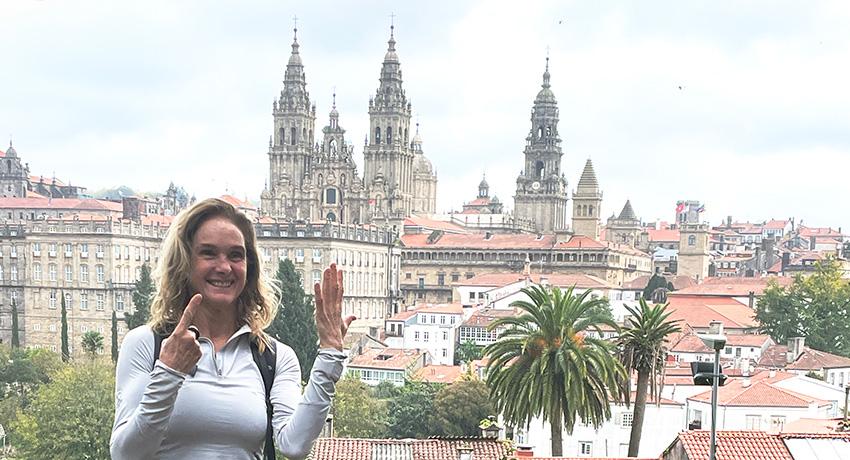pilgrim with Santiago Cathedral in background from a distance