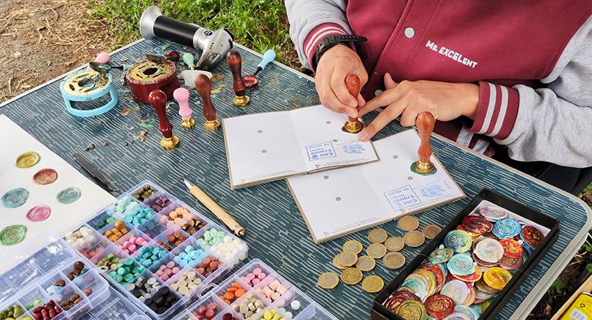 worker adding custom stamps to passport along the Camino