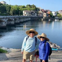 Two lady pilgrims walking el Camino along the waterfront