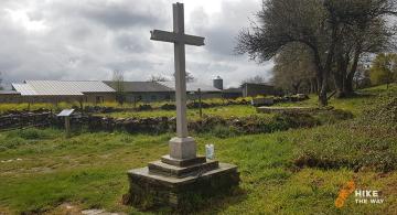 Cross by Venta de Naron chapel with pilgrim keepsake box