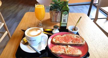 breakfast tray showing coffee, fresh ground tomato, olive oil and orange juice