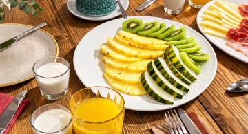 breakfast plate with fresh fruit and juices