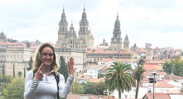 pilgrim with Santiago Cathedral in background from a distance